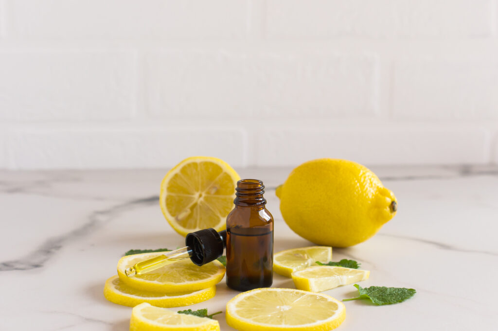 moisturizing facial oil with citrus extract against the background of lemon slices and white background. the concept of face and body care.